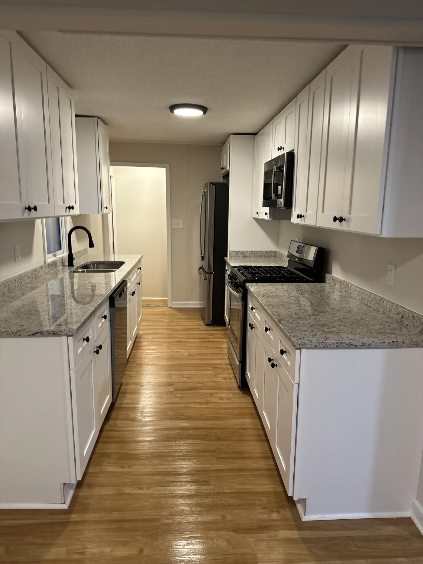 Sparkling clean kitchen after a Grime Guardians move-out clean - countertops, cabinets, and floors spotless